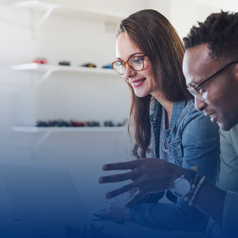 man-and-woman-talk-while-looking-at-computer