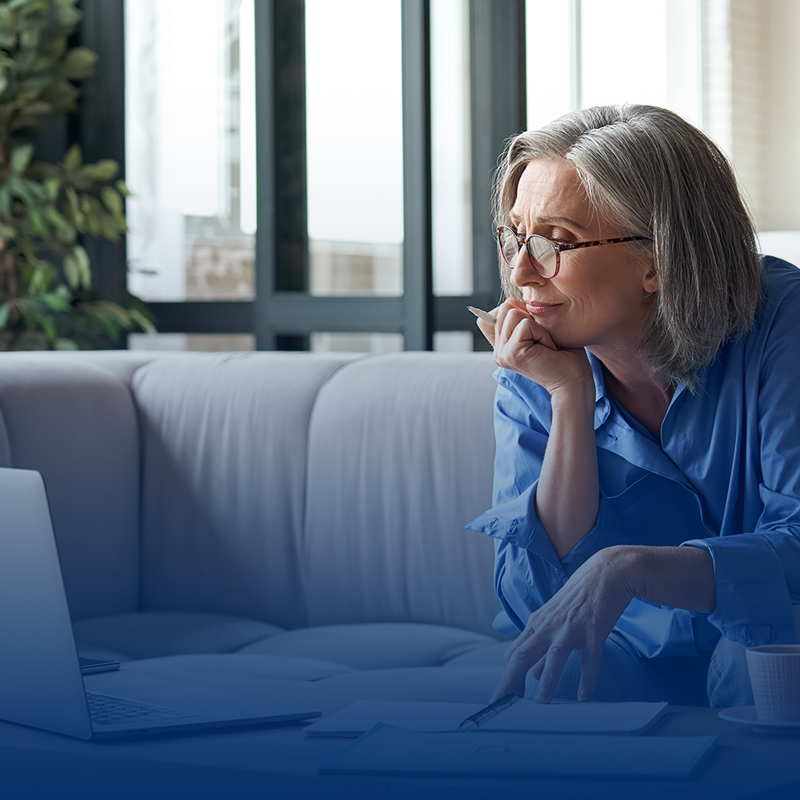 older-woman-hand-on-chin-looking-at-computer