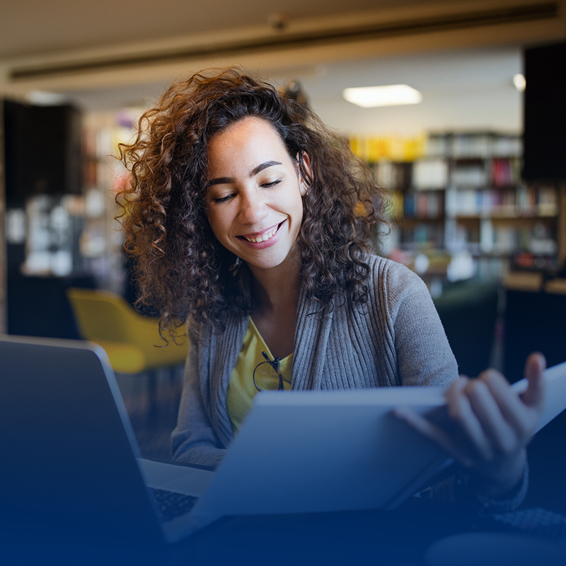 woman-smiling-studying-looking-at-notebook