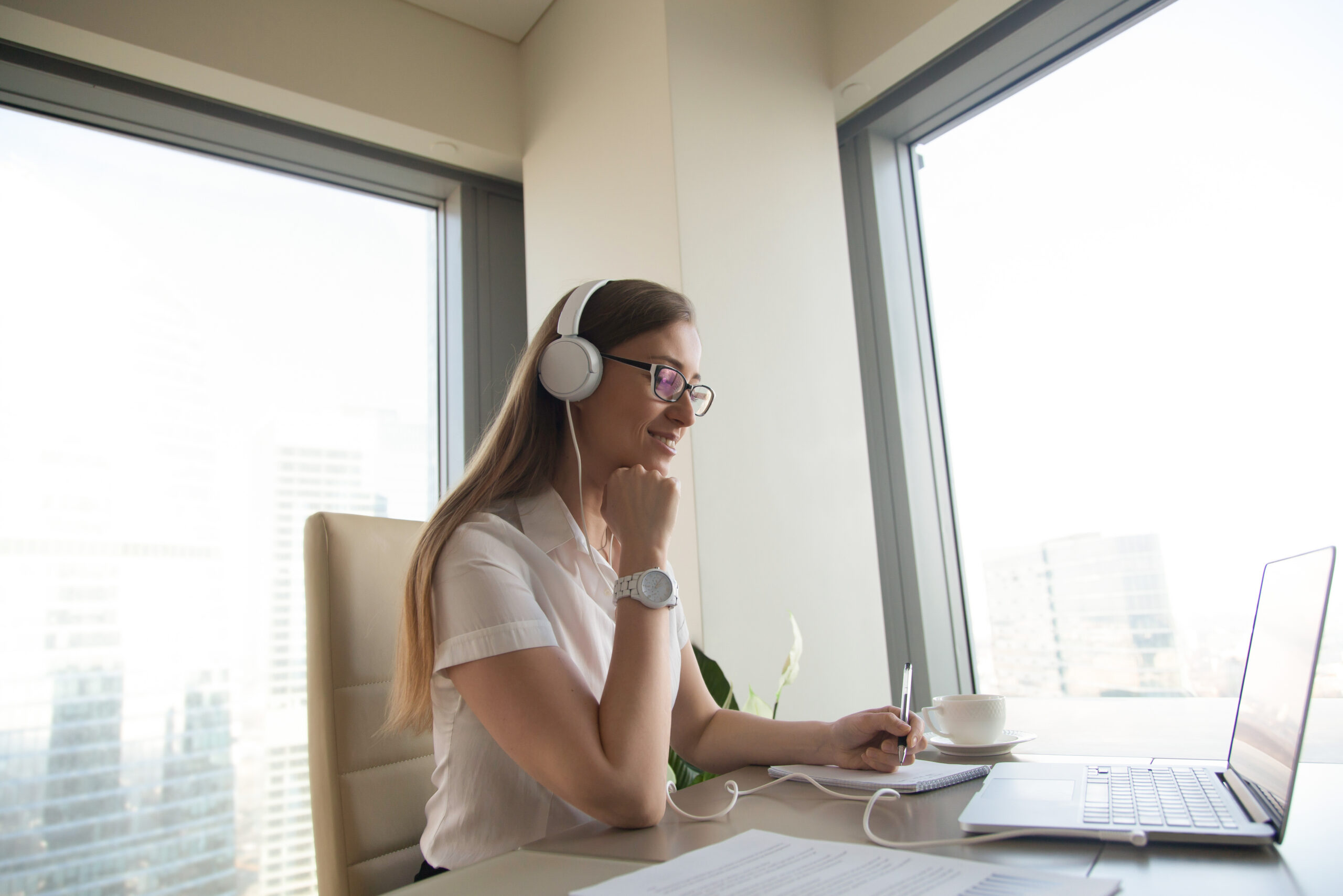 Businesswoman takes part in online meeting Coach-Approach-Training-Institute-Logo-Full-Color-Icon-Transparent-Background